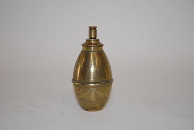 an image of a gold colored metal object on a white surface