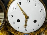two clocks that are sitting side by side on a table