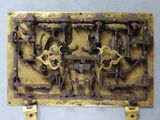 a metal plaque with a bunch of gears on it