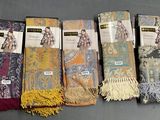 six pairs of scarves are lined up in a row on a table