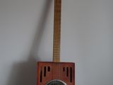 a guitar sitting on top of a table next to a speaker