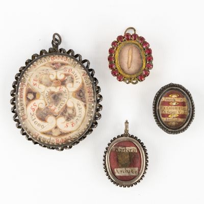 three pendants of various shapes and sizes are displayed on a white surface