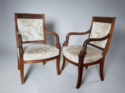 two chairs with upholstered upholstered back and arms