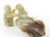 pair of jade figurines of a man and a woman on a horse