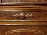 a close up of a wooden cabinet with a drawer