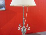 a lamp that is on a table with a red wall in the background