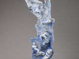 an image of a sculpture of a person on a rock