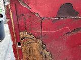 a red box with a painting of a man on it