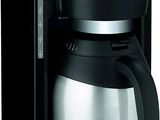 the coffee maker is black and silver with a glass carafeo