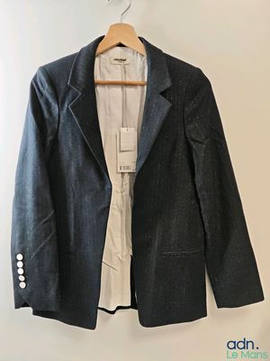 jacket hanging on a hanger on a wall in a room