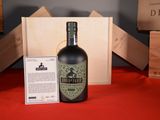 a bottle of liquor sitting next to a box on a table