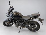 a black motorcycle that is parked on a white floor