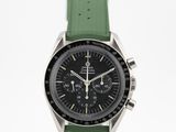 an image of a watch with a green strap on a white surface