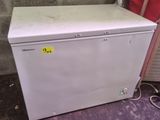 an image of a small white refrigerator in a room