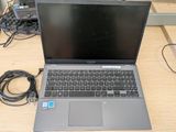 a laptop that is sitting on a table with wires