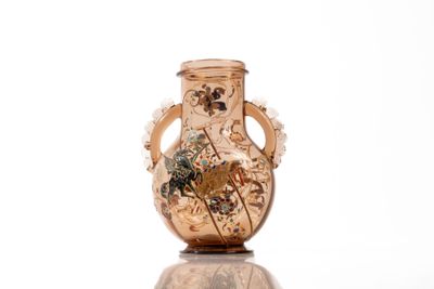 a vase that has a picture on it on a table