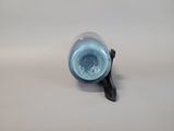 a blue vase with a black handle on a white surface