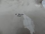 a white vase with a black writing on it