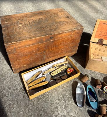 a wooden box with a pair of shoes and a pair of scissors in it