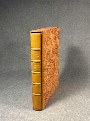 an old book sitting on top of a table next to a gray background