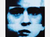 a black and white photo of a man ' s face with a blue background