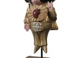 figurine of elvis presley on a wooden box with a clock