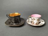 two cups and saucers are sitting on a table