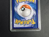 a close up of a pokemon card in a plastic case