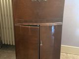 a small wooden cabinet in the corner of a room