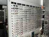 many glasses on display in a store with a lot of them