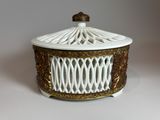 a white and gold birdcage sitting on a white table