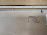 a sign on the side of a refrigerator that is not in use