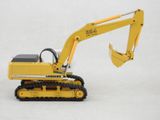 a yellow toy excavator that is sitting on a white surface