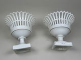 pair of white light fixtures on a wall with a white background
