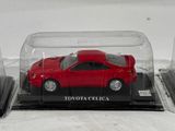 a red toy car in a glass case on a table