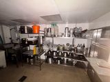 many pots and pans on the shelves in the kitchen
