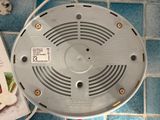 an overhead view of a smoke detector on a tiled floor
