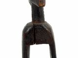 a small wooden sculpture of a person sitting on a chair
