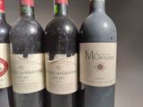 several bottles of wine are lined up on a table