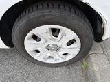 a white car with a flat tire on the street