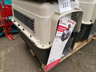 a dog crate with a dog in it on a pallet