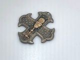 a metal pin with a baseball bat and a baseball bat on it