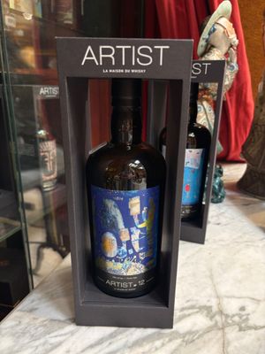 bottles of wine are sitting on a table in front of a glass case