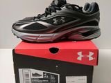 a pair of black and red shoes on top of a box