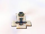 a small cross with a blue and white design on it