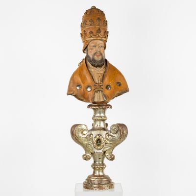 statue of a bust of a man with a crown on top of a pedestal