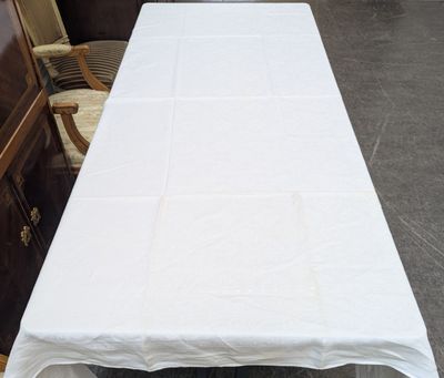 a table with a white tablecloth on it in a room