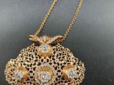 a close up of a gold and diamond purse on a black surface