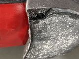 a close up of a red and black object with a hole in it