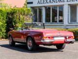 a red convertible car parked in front of a building